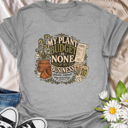 Plant Budget t-shirt for plant lovers, plant moms, and houseplant collectors who know their spending habits are none of anyone’s business.
The vintage botanical design features potted plants, plant tags, gardening details, and bold humorous lettering.
It is perfect for plant parents who love adding just one more pothos, monstera, succulent, or leafy friend to the collection.
A funny gift for houseplant lovers, indoor gardeners, and anyone whose plant budget is best left unspoken.