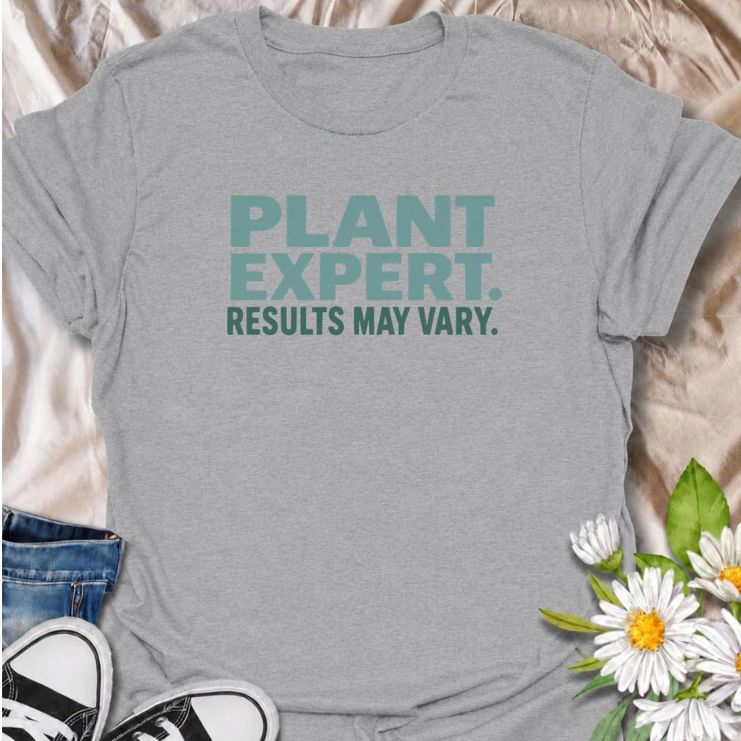 A funny plant T-shirt for anyone who gives great houseplant advice but knows the results are never guaranteed. The phrase “Plant Expert. Results May Vary.” adds dry, self-deprecating humor without overcomplicating the design. Perfect for plant parents, houseplant collectors, indoor gardeners, and anyone who has learned that every plant has a mind of its own. The clean typography makes it an easy everyday shirt and a fun gift for experienced growers and enthusiastic beginners alike. Ideal for nursery trips, 