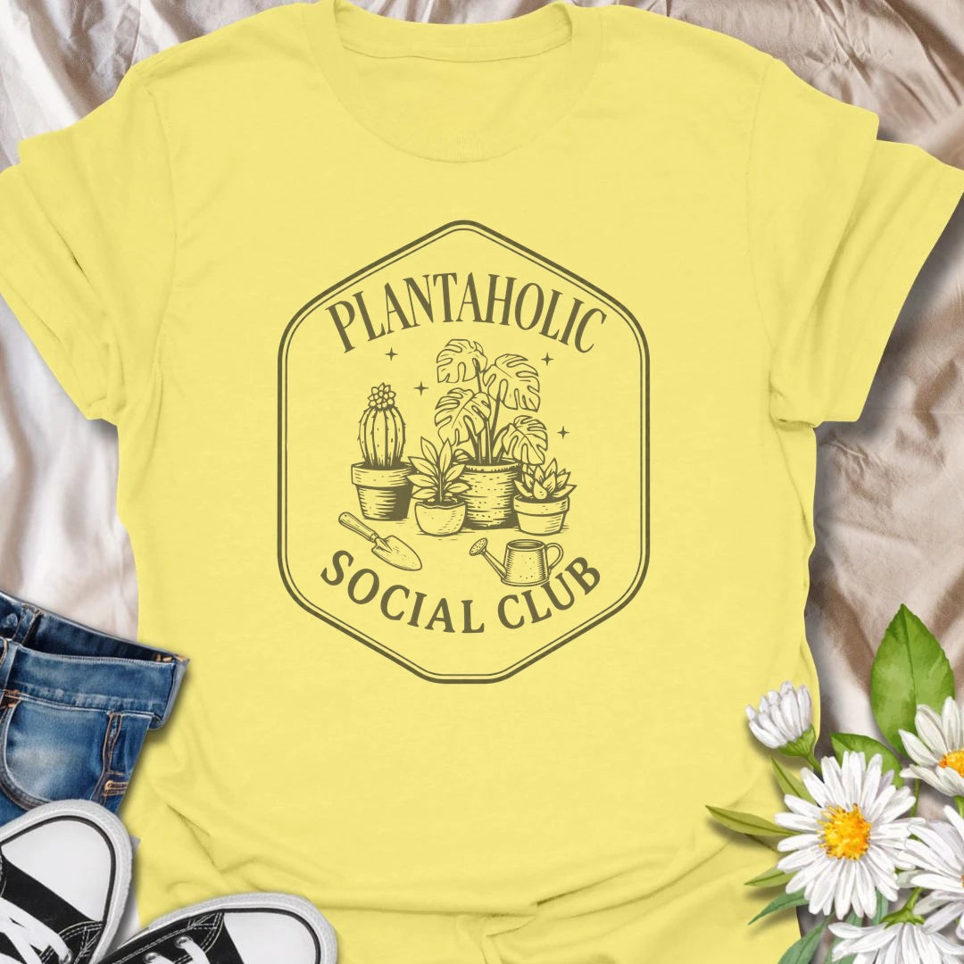 Plantaholic Social Club t-shirt for houseplant collectors who proudly admit the plant obsession is real.
The badge-style design with potted plants, tools, and vintage lettering gives it a fun club-member feel.
It is perfect for plant moms, indoor gardeners, and anyone whose social life includes checking new leaves.
A great gift for plant lovers who belong in a club made entirely of leafy friends and fellow plant addicts.