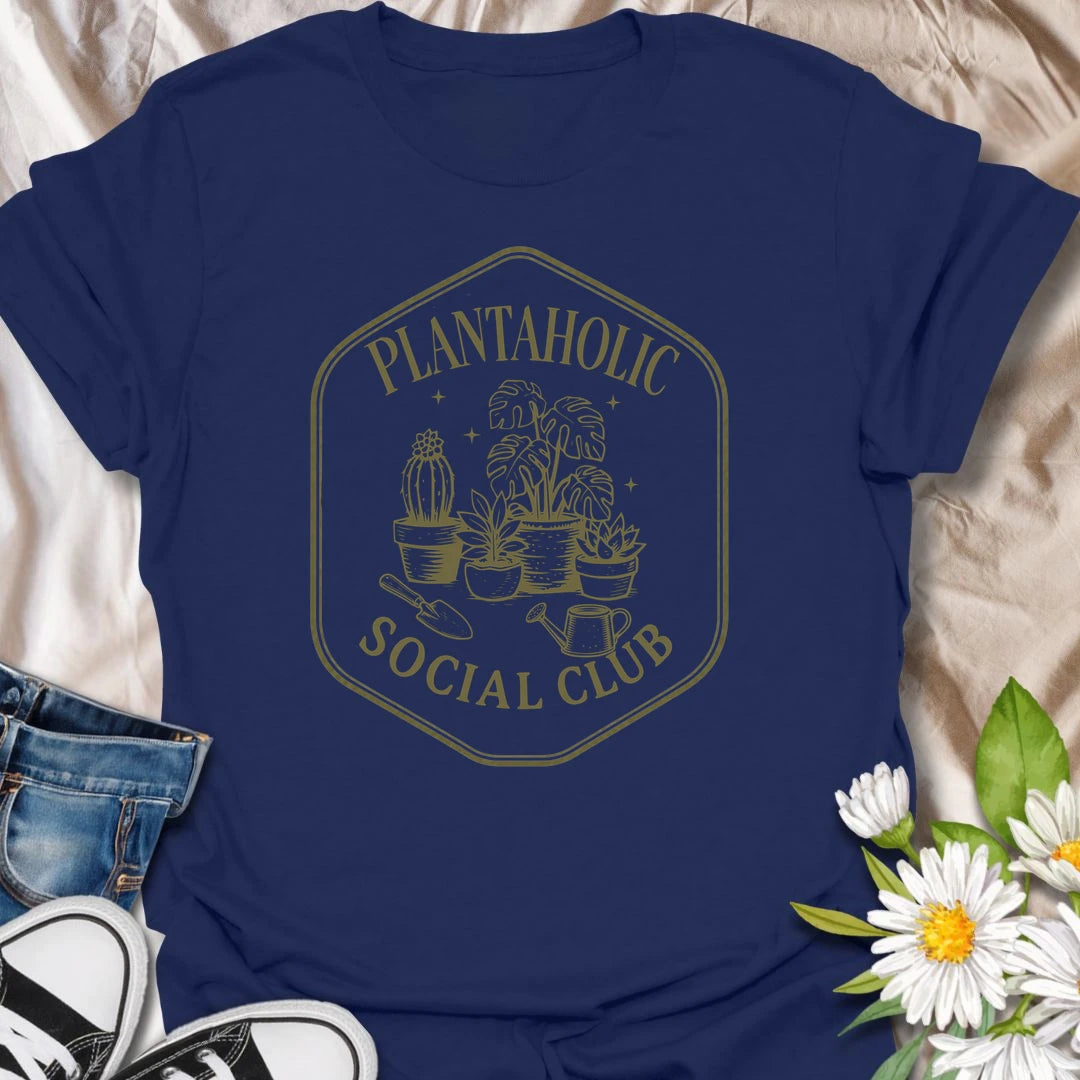 Plantaholic Social Club t-shirt for houseplant collectors who proudly admit the plant obsession is real.
The badge-style design with potted plants, tools, and vintage lettering gives it a fun club-member feel.
It is perfect for plant moms, indoor gardeners, and anyone whose social life includes checking new leaves.
A great gift for plant lovers who belong in a club made entirely of leafy friends and fellow plant addicts.