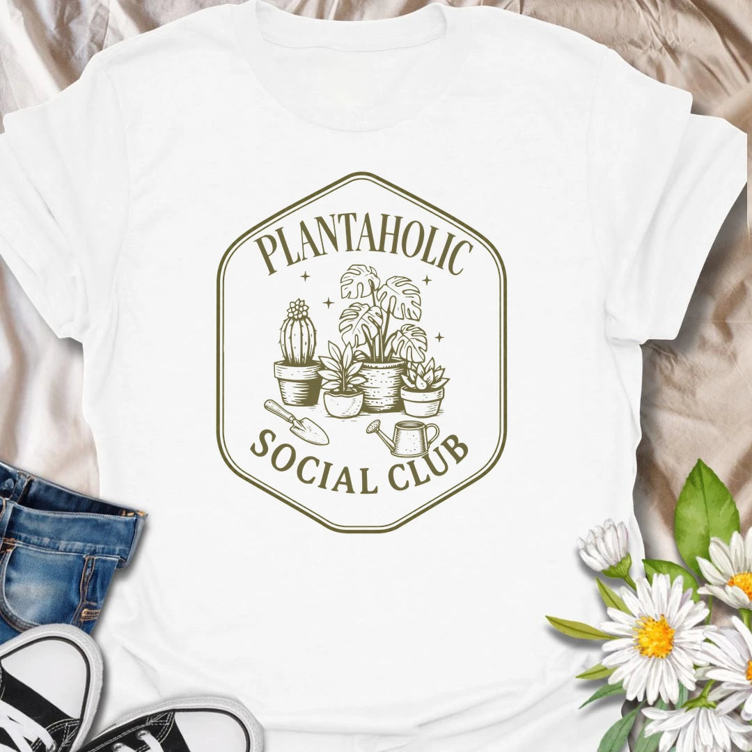 Plantaholic Social Club t-shirt for houseplant collectors who proudly admit the plant obsession is real.
The badge-style design with potted plants, tools, and vintage lettering gives it a fun club-member feel.
It is perfect for plant moms, indoor gardeners, and anyone whose social life includes checking new leaves.
A great gift for plant lovers who belong in a club made entirely of leafy friends and fellow plant addicts.