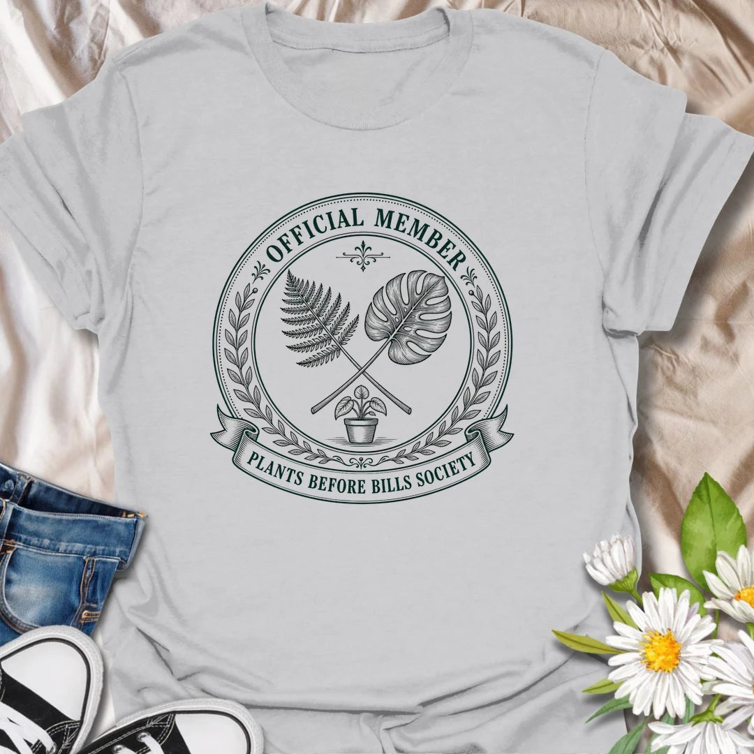 Plants Before Bills t-shirt for plant lovers who know their priorities are leafy, rooted, and usually sitting in a pot.
The official member badge design gives this shirt a vintage botanical society feel with fern, monstera, and potted plant details.
It is perfect for plant moms, houseplant collectors, indoor gardeners, and anyone tempted by plants before responsibilities.
A funny gift for plant people who proudly belong to the plants-before-bills lifestyle.