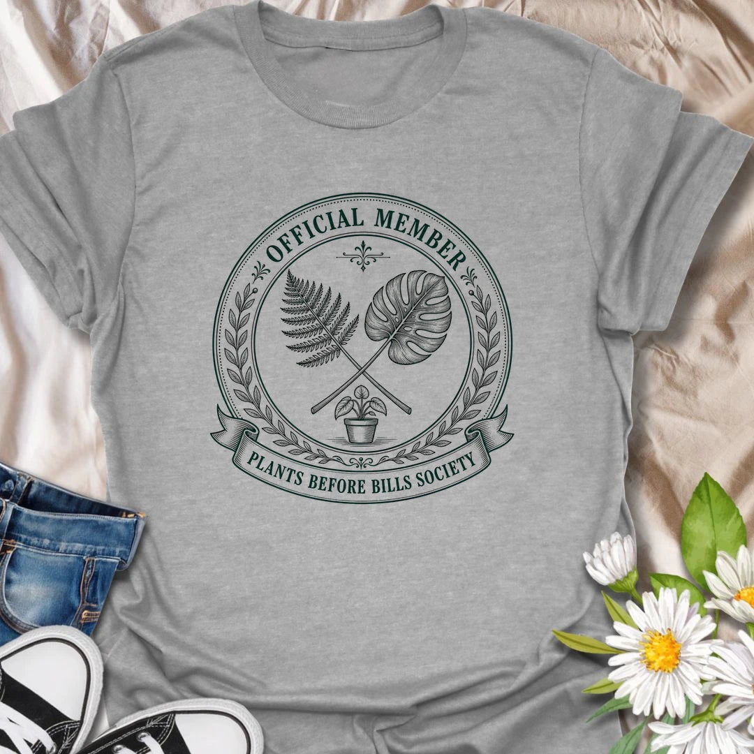 Plants Before Bills t-shirt for plant lovers who know their priorities are leafy, rooted, and usually sitting in a pot.
The official member badge design gives this shirt a vintage botanical society feel with fern, monstera, and potted plant details.
It is perfect for plant moms, houseplant collectors, indoor gardeners, and anyone tempted by plants before responsibilities.
A funny gift for plant people who proudly belong to the plants-before-bills lifestyle.