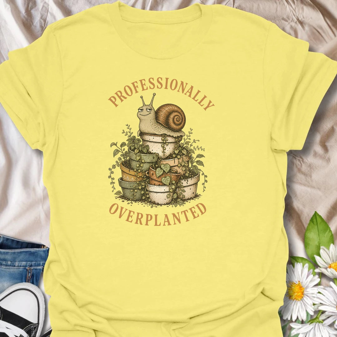 This Professionally Overplanted t-shirt is perfect for gardeners and plant lovers who know there is always room for one more pot. Featuring a smug garden snail sitting on a stack of overflowing potted plants, this funny botanical design is great for houseplant collectors, container gardeners, plant moms, plant dads, and anyone proudly guilty of overplanting.