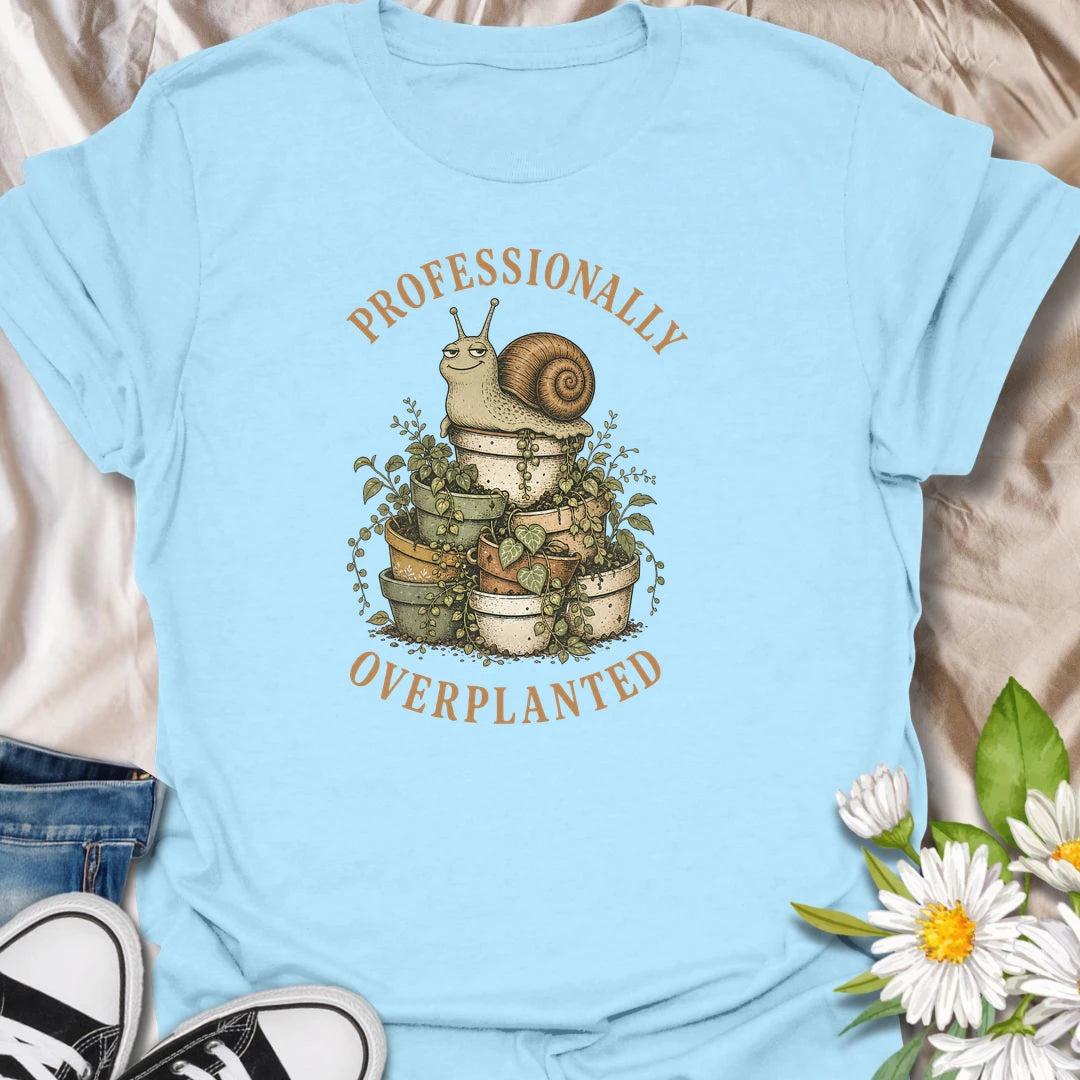 This Professionally Overplanted t-shirt is perfect for gardeners and plant lovers who know there is always room for one more pot. Featuring a smug garden snail sitting on a stack of overflowing potted plants, this funny botanical design is great for houseplant collectors, container gardeners, plant moms, plant dads, and anyone proudly guilty of overplanting.