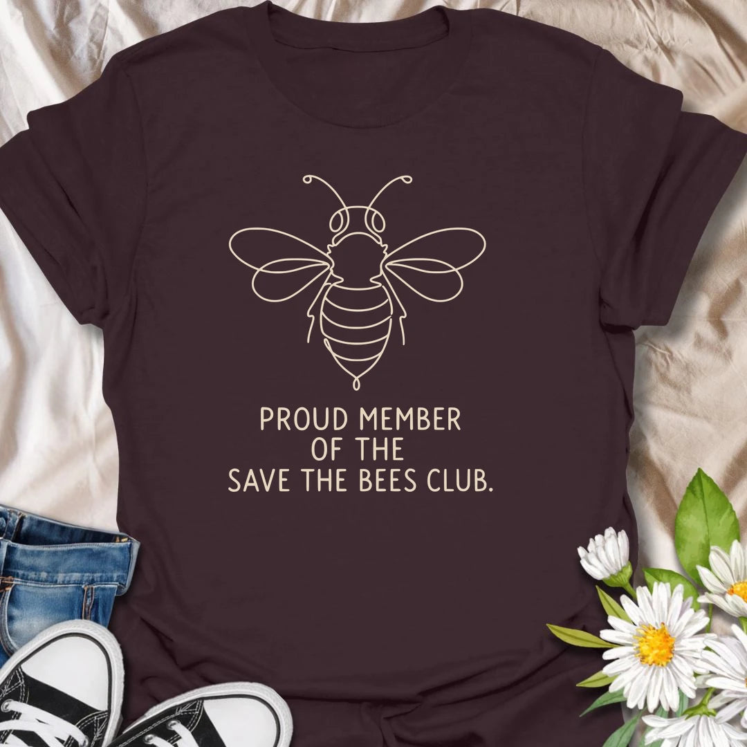 This Proud Member Of The Save The Bees Club t-shirt is perfect for bee lovers, gardeners, and pollinator supporters. Featuring a simple white line-art bee with bold text, this clean botanical design is great for wildflower gardeners, nature lovers, pollinator garden fans, and anyone who wants to celebrate bees and the important work they do.