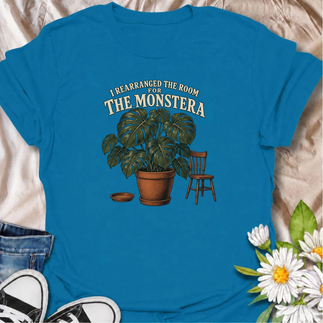 A funny houseplant T-shirt for anyone who has ever reorganized an entire room just to make one plant fit better. Featuring an oversized monstera beside a simple chair, this design is perfect for plant parents who know the furniture sometimes has to adapt to the greenery. The phrase “I Rearranged the Room for the Monstera” captures the reality of living with a rapidly growing indoor jungle. It makes a great gift for monstera lovers, houseplant collectors, and anyone who plans their home around their plants. 