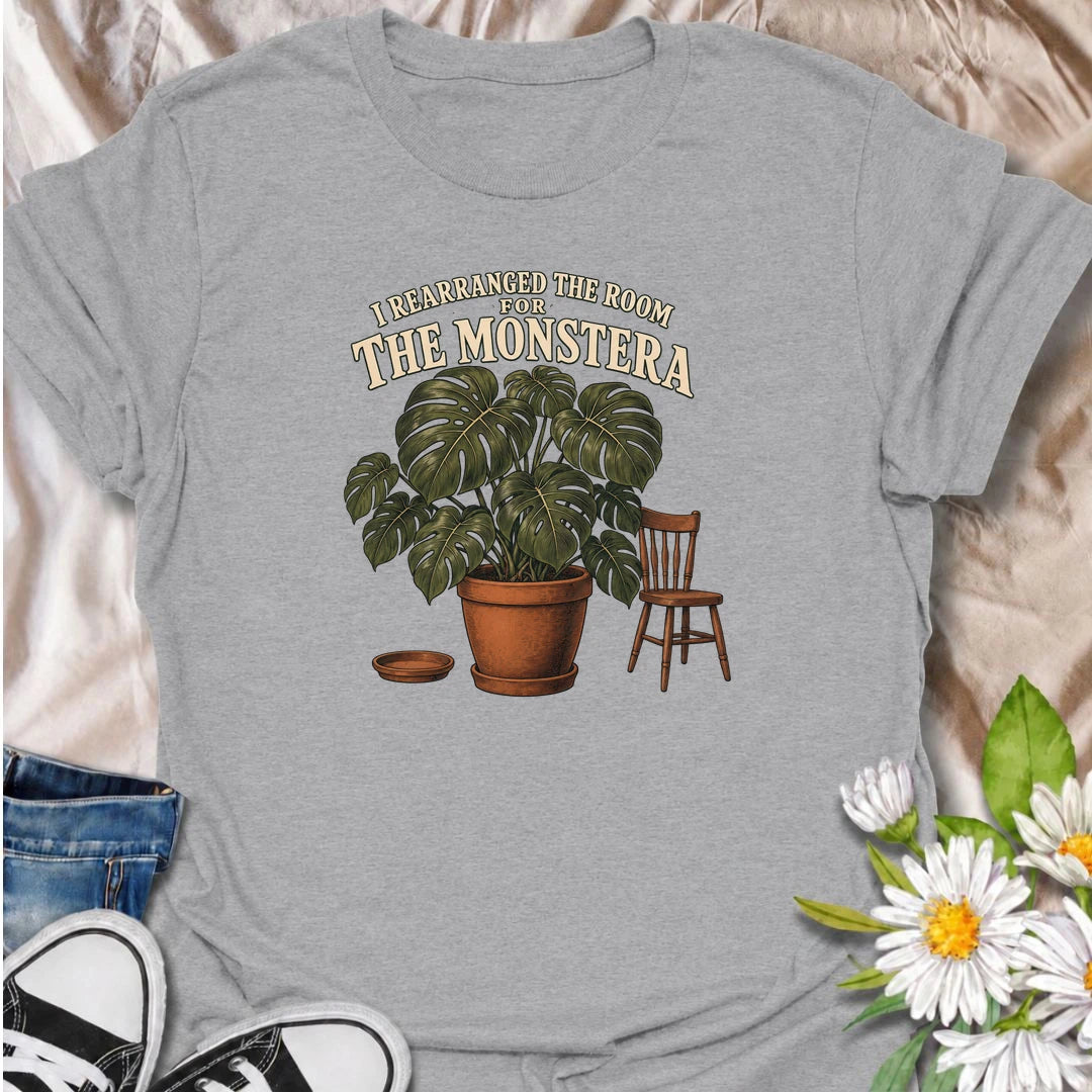 A funny houseplant T-shirt for anyone who has ever reorganized an entire room just to make one plant fit better. Featuring an oversized monstera beside a simple chair, this design is perfect for plant parents who know the furniture sometimes has to adapt to the greenery. The phrase “I Rearranged the Room for the Monstera” captures the reality of living with a rapidly growing indoor jungle. It makes a great gift for monstera lovers, houseplant collectors, and anyone who plans their home around their plants. 
