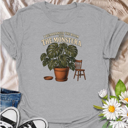 A funny houseplant T-shirt for anyone who has ever reorganized an entire room just to make one plant fit better. Featuring an oversized monstera beside a simple chair, this design is perfect for plant parents who know the furniture sometimes has to adapt to the greenery. The phrase “I Rearranged the Room for the Monstera” captures the reality of living with a rapidly growing indoor jungle. It makes a great gift for monstera lovers, houseplant collectors, and anyone who plans their home around their plants. 