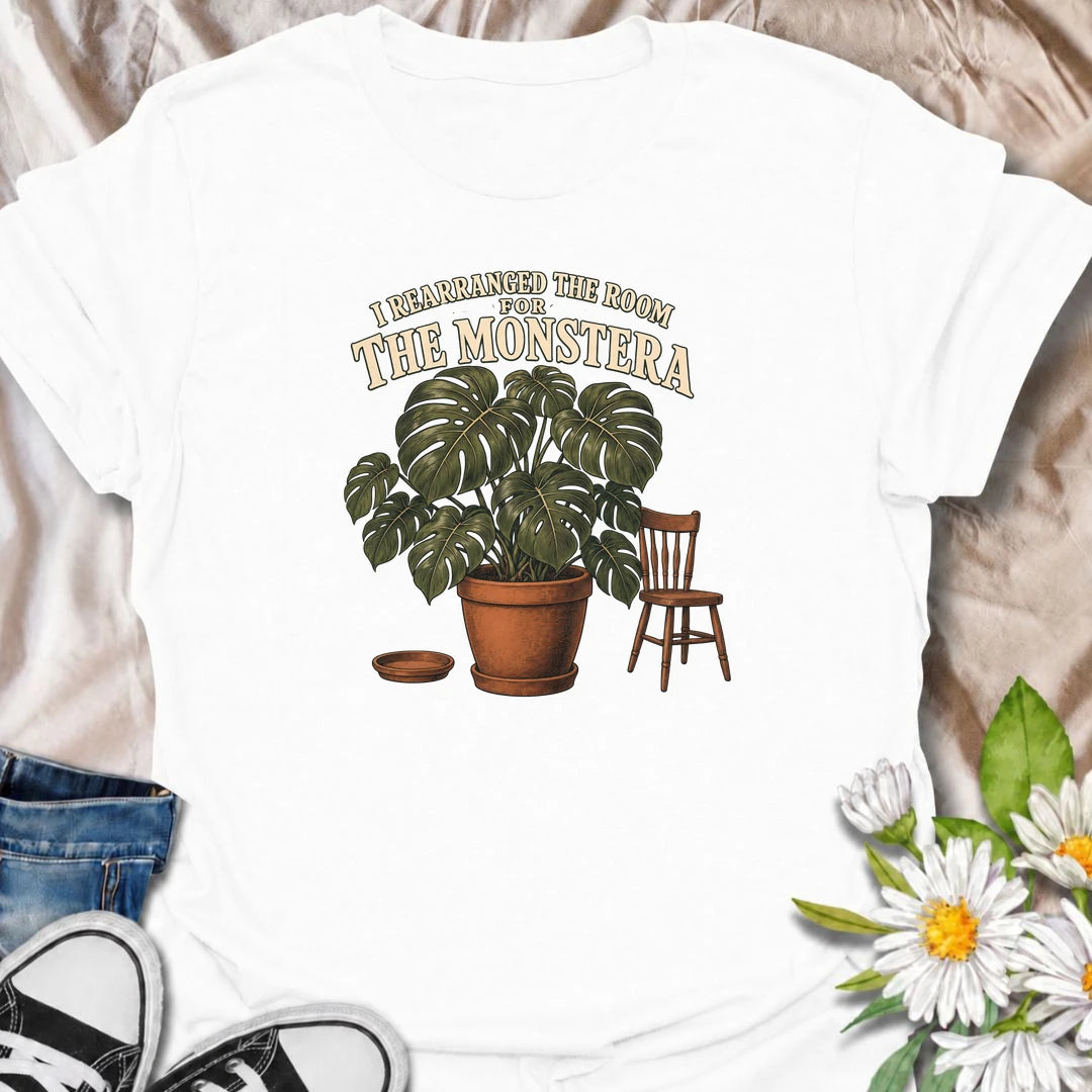 A funny houseplant T-shirt for anyone who has ever reorganized an entire room just to make one plant fit better. Featuring an oversized monstera beside a simple chair, this design is perfect for plant parents who know the furniture sometimes has to adapt to the greenery. The phrase “I Rearranged the Room for the Monstera” captures the reality of living with a rapidly growing indoor jungle. It makes a great gift for monstera lovers, houseplant collectors, and anyone who plans their home around their plants. 