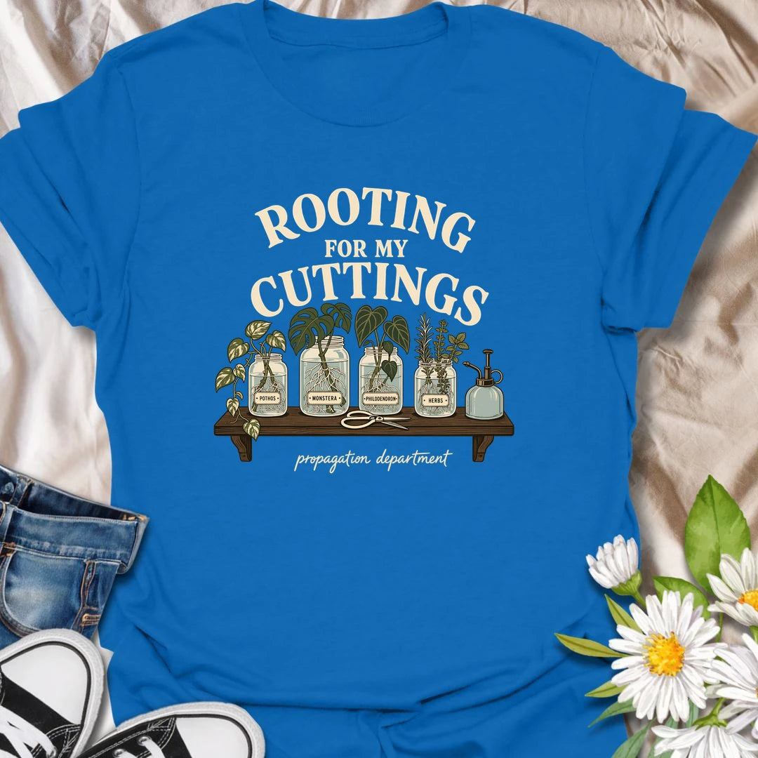 Cheer on every new root with this “Rooting for My Cuttings” T-shirt. The propagation-themed design features pothos, monstera, philodendron, and herb cuttings growing in glass jars. It is a thoughtful and funny gift for houseplant lovers who are always starting another plant baby.