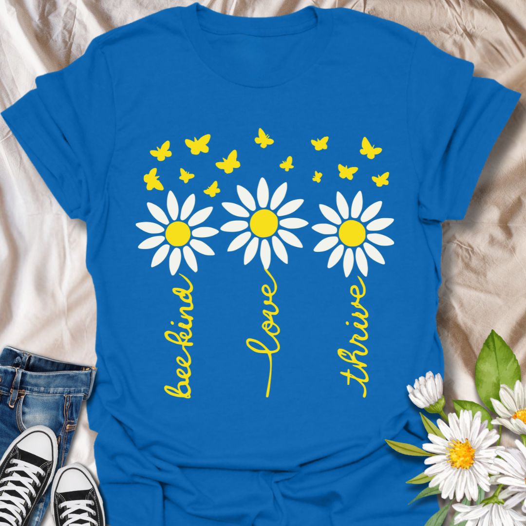 Inspire positivity with this uplifting floral graphic t-shirt featuring hand-lettered words be kind, love, thrive paired with charming daisies and fluttering butterflies. A perfect gift for flower lovers, kind souls, and anyone