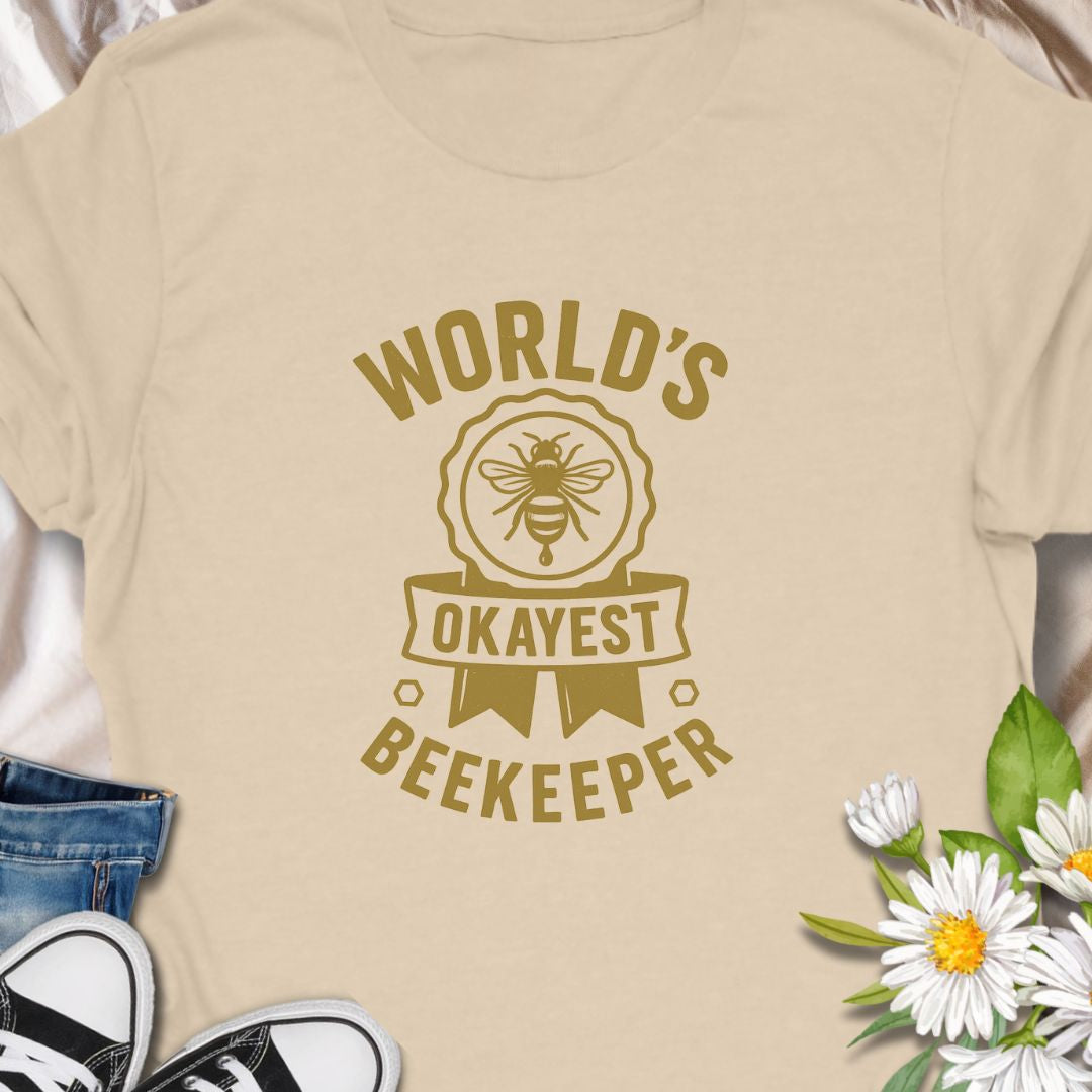 Celebrate your love for beekeeping with a humorous twist in this "World's Okayest Beekeeper" T-Shirt. Perfect for backyard beekeepers, honey lovers, and bee enthusiasts who know it's not about perfection—it's about passion. Makes a great gift for bee dads, moms, hobbyists, and anyone who keeps buzzing through life.