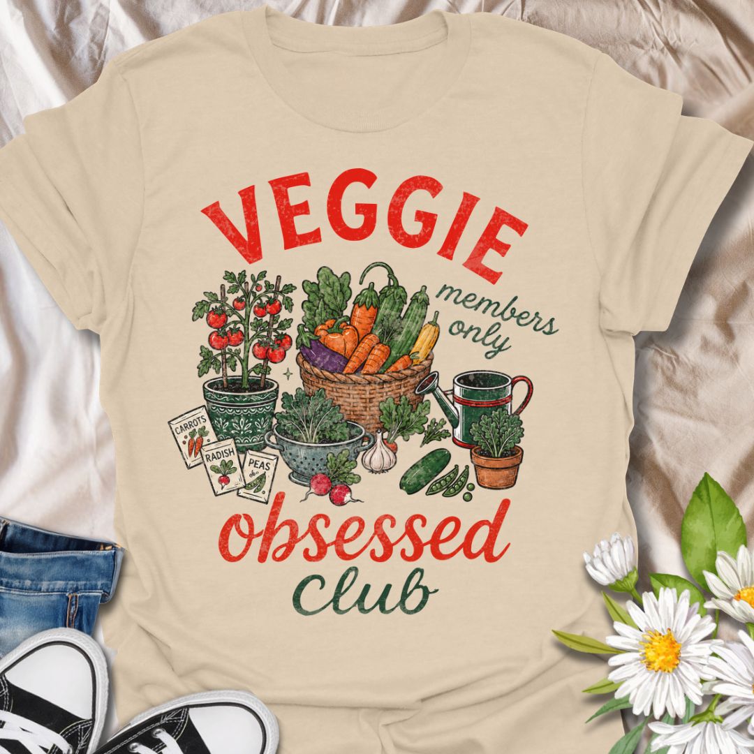 This Veggie Obsessed Club t-shirt is perfect for gardeners, vegetable lovers, and homegrown food fans. Featuring a colorful illustrated harvest scene with tomatoes, carrots, cucumbers, seed packets, and a watering can, this fun gardening tee is great for anyone who loves growing their own food and spending time in the garden.