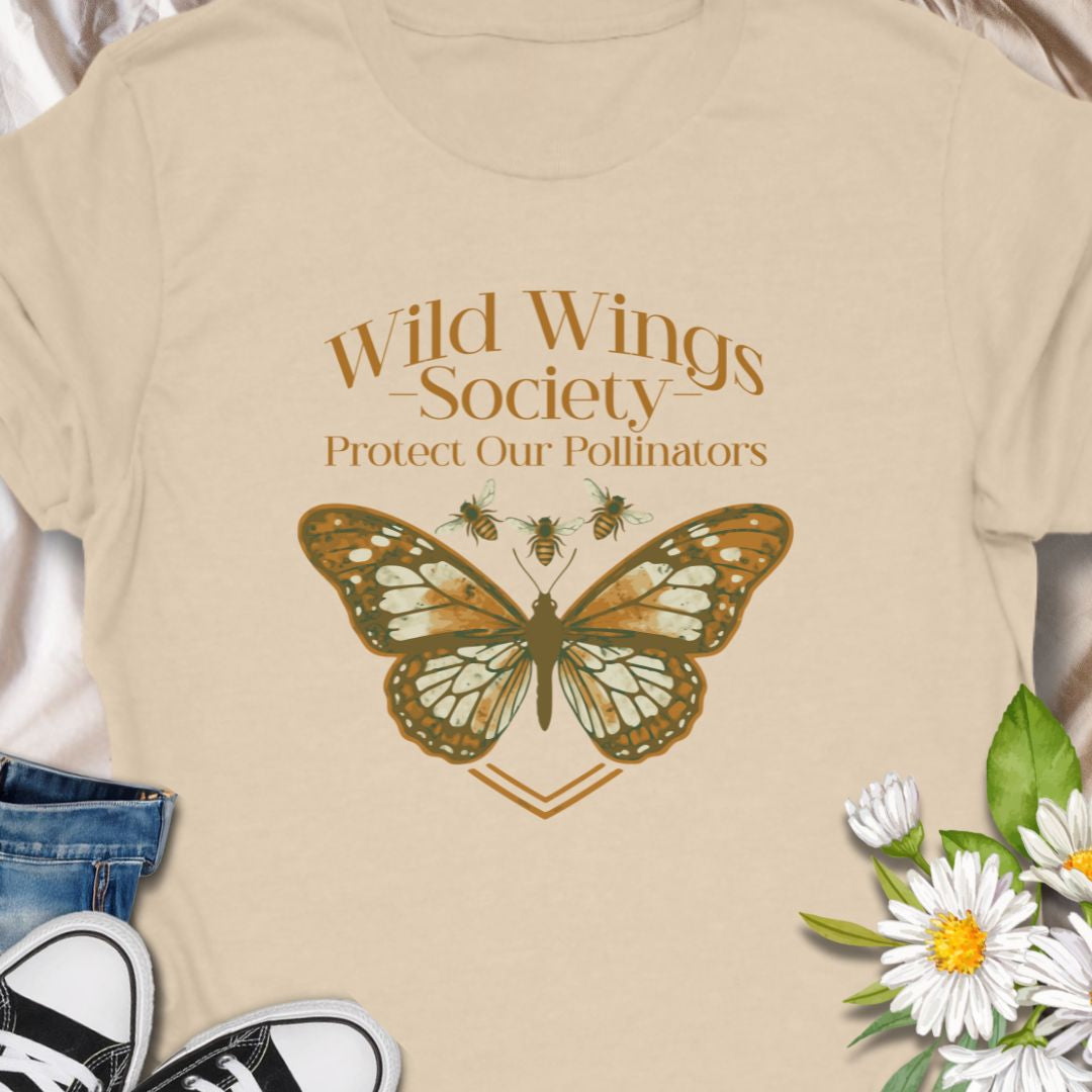 Butterfly conservation themed shirt with 'Wild Wings Society' design. Great for nature lovers and pollinator protectors.   Soft, worn-in comfort meets quiet activism - a warm-toned monarch rests at the center of a vintage-inspired crest, with the words “Wild Wings Society — Protect Our Pollinators” arched above. 