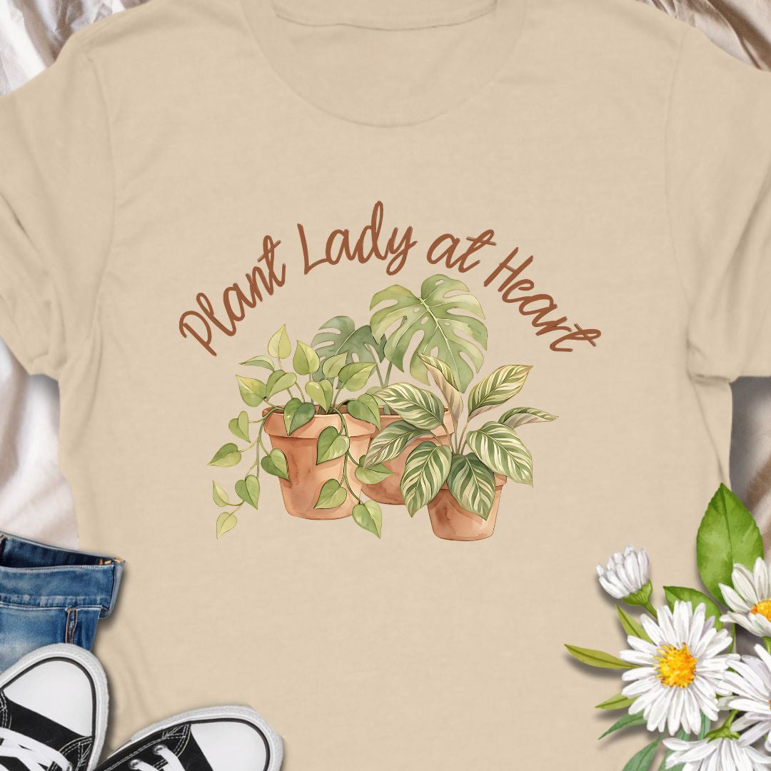 Celebrate your love for greenery with this charming “Plant Lady at Heart” t-shirt. Featuring soft water color-style potted plants and elegant script text, it’s the perfect gift for plant moms, gardeners, and nature enthusiasts. Wear it proudly and show the world that your heart truly belongs to plants—comfort meets style in this must-have tee.