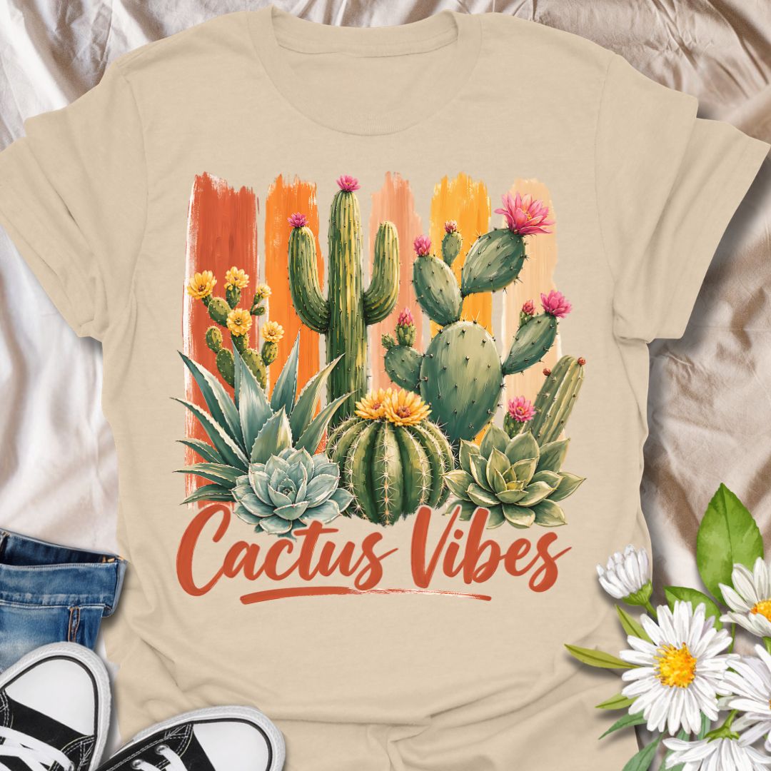 This Cactus Vibes t-shirt is made for plant lovers who are drawn to desert plants, succulents, and bold botanical artwork. Featuring a colorful cactus and succulent arrangement with painterly brushstroke accents, blooming prickly pear flowers, agave, and warm earthy lettering, this design has a bright southwestern garden feel. Perfect for cactus lovers, succulent fans, plant moms, plant dads, desert plant collectors, and anyone who loves relaxed plant vibes.