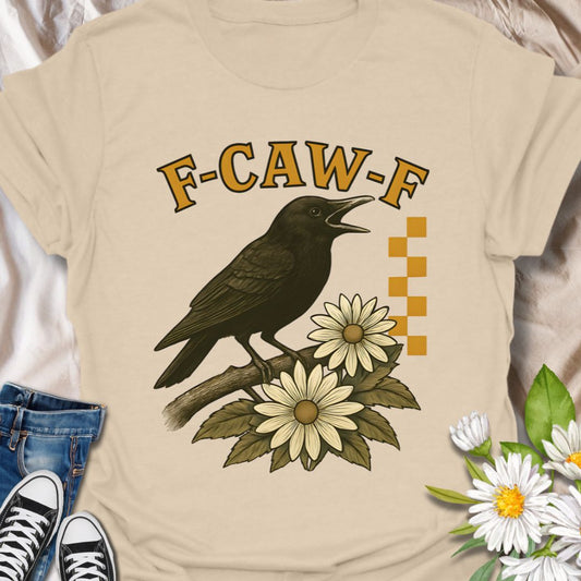 Add bold floral attitude to your wardrobe with this quirky crow and flower graphic tee featuring the cheeky phrase "F-CAW-F." Perfect for flower lovers with a sense of humor, nature enthusiasts, and cottagecore fans who enjoy a little edge in their aesthetic.