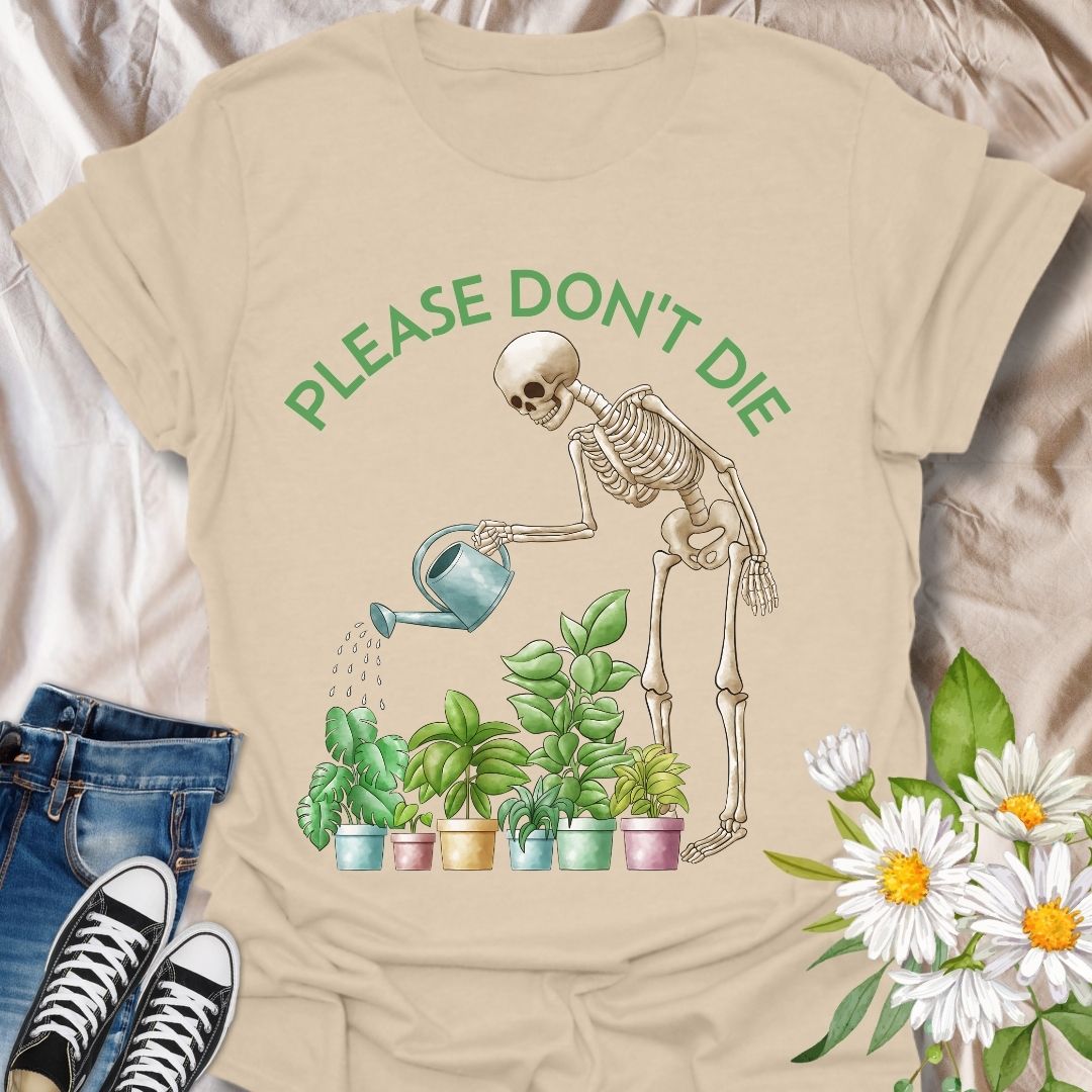 Funny plant lover t-shirt featuring a skeleton watering houseplants with the phrase 'Please don't die.' A dark humor gardening tee perfect for plant parents, indoor jungle fans, and anyone with a green thumb and a sense of humor. Great gift for plant moms, goth gardeners, and sarcastic plant enthusiasts. Sand