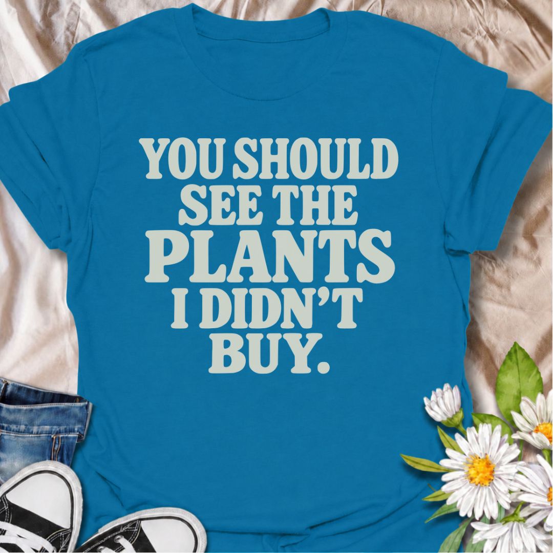 A funny plant T-shirt for anyone whose restraint deserves at least a little recognition. The phrase “You Should See the Plants I Didn’t Buy” delivers dry, self-aware humor that plant parents, nursery regulars, and houseplant collectors will instantly understand. Its bold retro typography keeps the design simple, readable, and easy to wear. It makes a great gift for plant lovers who somehow manage to leave the garden center with fewer plants than they wanted. Perfect for nursery trips, plant swaps, casual we