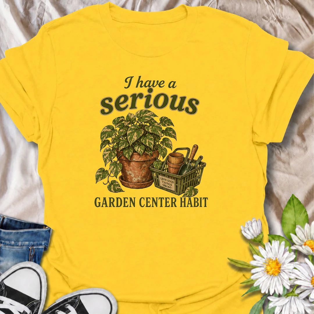 A funny plant T-shirt for anyone who treats a trip to the garden center like a completely normal weekly habit. Featuring a leafy houseplant, terracotta pots, and a basket of gardening tools, this design is perfect for plant parents and nursery regulars. The phrase “I Have a Serious Garden Center Habit” captures the familiar problem of going in for one thing and coming home with another plant. It makes a great gift for houseplant lovers, indoor gardeners, and anyone who can never resist a nursery visit. Idea