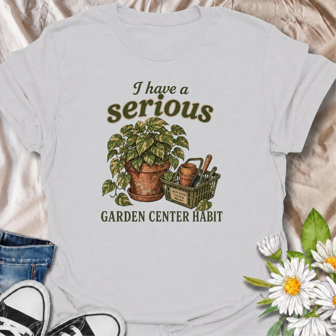 A funny plant T-shirt for anyone who treats a trip to the garden center like a completely normal weekly habit. Featuring a leafy houseplant, terracotta pots, and a basket of gardening tools, this design is perfect for plant parents and nursery regulars. The phrase “I Have a Serious Garden Center Habit” captures the familiar problem of going in for one thing and coming home with another plant. It makes a great gift for houseplant lovers, indoor gardeners, and anyone who can never resist a nursery visit. Idea