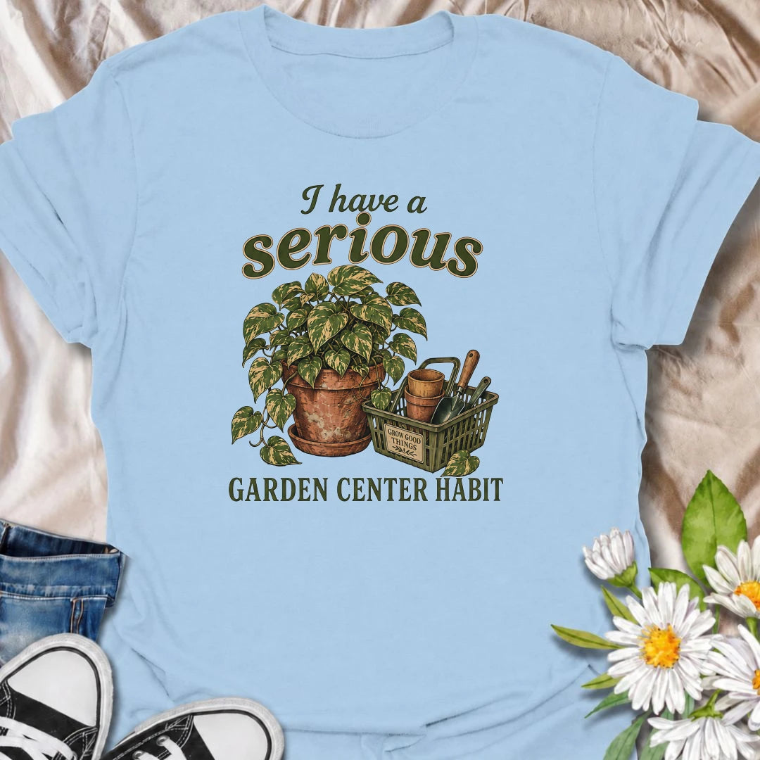 A funny plant T-shirt for anyone who treats a trip to the garden center like a completely normal weekly habit. Featuring a leafy houseplant, terracotta pots, and a basket of gardening tools, this design is perfect for plant parents and nursery regulars. The phrase “I Have a Serious Garden Center Habit” captures the familiar problem of going in for one thing and coming home with another plant. It makes a great gift for houseplant lovers, indoor gardeners, and anyone who can never resist a nursery visit. Idea