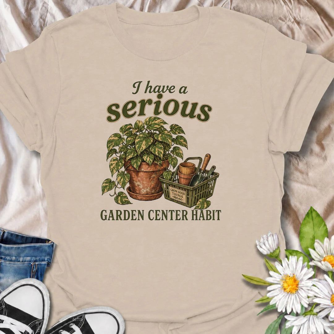 A funny plant T-shirt for anyone who treats a trip to the garden center like a completely normal weekly habit. Featuring a leafy houseplant, terracotta pots, and a basket of gardening tools, this design is perfect for plant parents and nursery regulars. The phrase “I Have a Serious Garden Center Habit” captures the familiar problem of going in for one thing and coming home with another plant. It makes a great gift for houseplant lovers, indoor gardeners, and anyone who can never resist a nursery visit. Idea