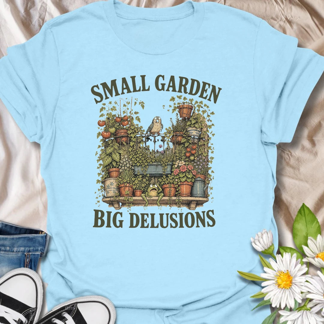 This Small Garden Big Delusions t-shirt is perfect for gardeners who believe every tiny patio, balcony, porch, or backyard can become a full botanical paradise. Featuring an overflowing container garden with tomatoes, flowers, potted plants, a frog, and a tiny bird, this funny gardening design is great for plant lovers, small-space gardeners, balcony growers, and anyone with big garden dreams.
