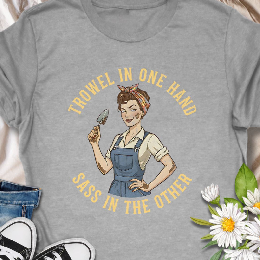 A bold, vintage-inspired gardening t-shirt featuring the phrase “Trowel in One Hand, Sass in the Other.” Perfect for confident gardeners, plant moms, and anyone who loves humor, dirt, and a little attitude in the garden.