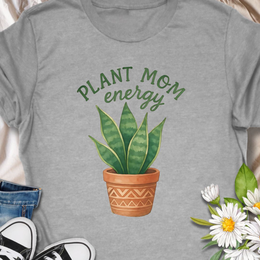 Show off your green thumb with this stylish “Plant Mom Energy” t-shirt featuring a beautiful snake plant in a terracotta pot. Perfect for indoor gardeners and houseplant lovers, this tee radiates nurturing vibes and earthy style. A cozy, cute wardrobe essential for any proud plant mom!
