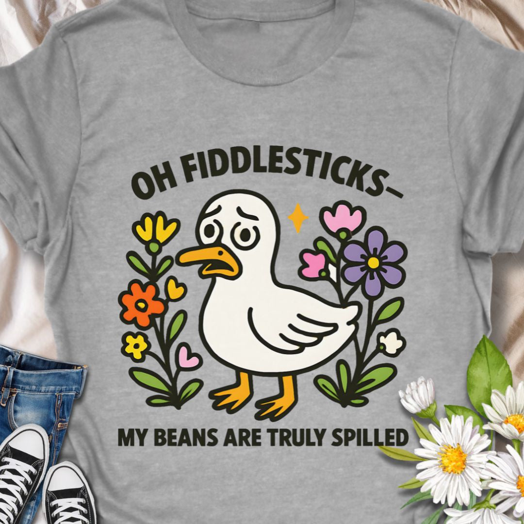 This adorable duck t-shirt featuring the phrase "Oh Fiddlesticks – My Beans Are Truly Spilled" blends wholesome humor with colorful floral charm. Perfect for anyone who thrives on quirky expressions and cute designs. Great gift for the emotionally expressive with the playful, slightly bewildered duck.  Wear it when you want to spark a smile, or share a goofy moment. 