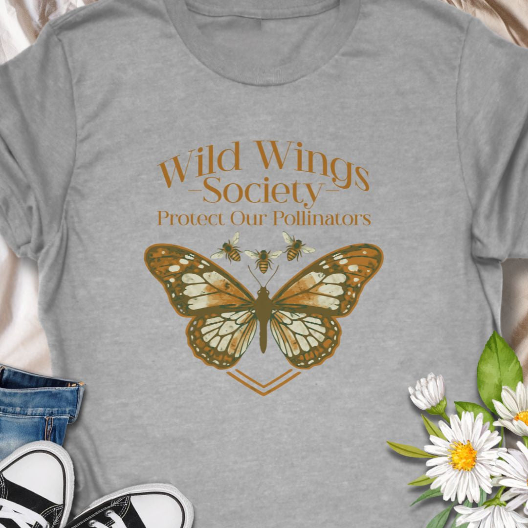 Butterfly conservation themed shirt with 'Wild Wings Society' design. Great for nature lovers and pollinator protectors.   Soft, worn-in comfort meets quiet activism - a warm-toned monarch rests at the center of a vintage-inspired crest, with the words “Wild Wings Society — Protect Our Pollinators” arched above. 