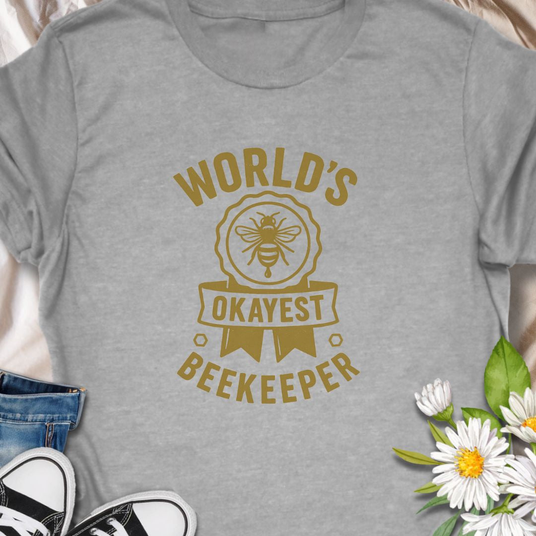 Celebrate your love for beekeeping with a humorous twist in this "World's Okayest Beekeeper" T-Shirt. Perfect for backyard beekeepers, honey lovers, and bee enthusiasts who know it's not about perfection—it's about passion. Makes a great gift for bee dads, moms, hobbyists, and anyone who keeps buzzing through life.