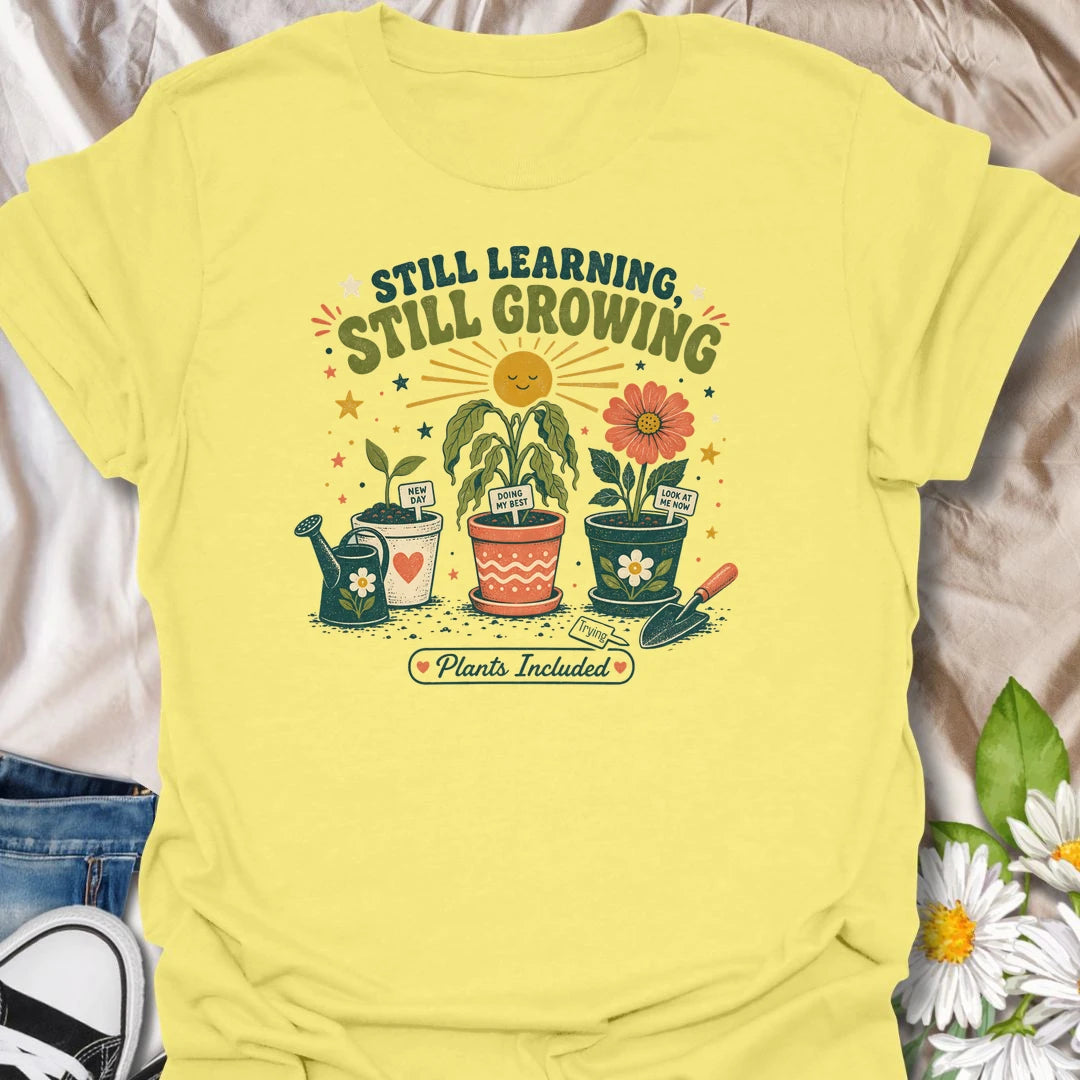 Encouraging plant t-shirt with cheerful garden pots, flowers, and a soft growth message for plant lovers and gardeners.