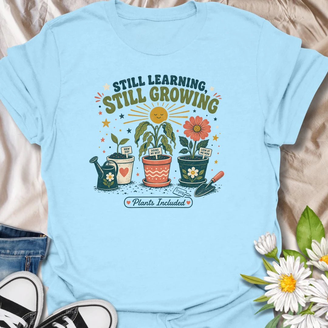 Encouraging plant t-shirt with cheerful garden pots, flowers, and a soft growth message for plant lovers and gardeners.
