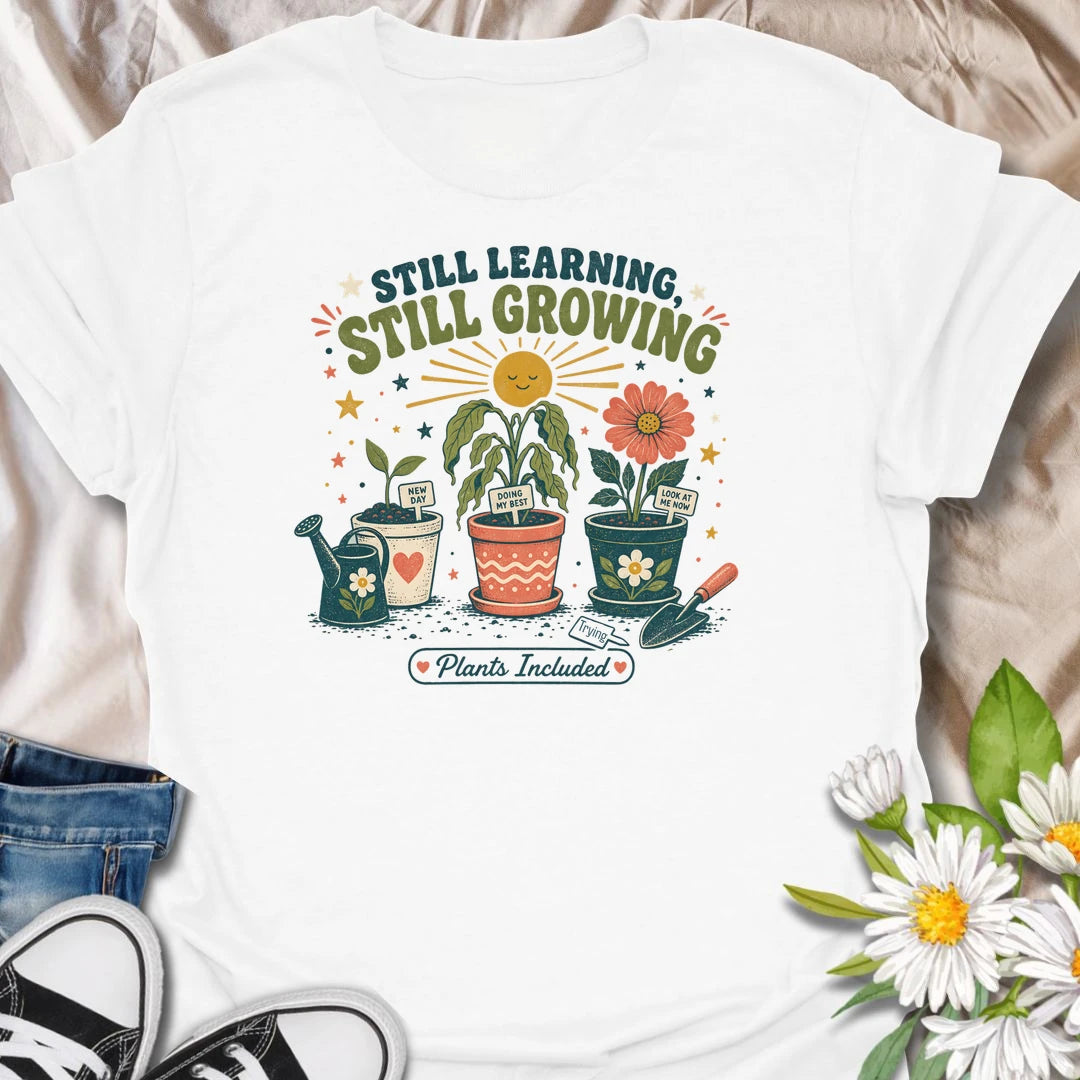 Encouraging plant t-shirt with cheerful garden pots, flowers, and a soft growth message for plant lovers and gardeners.