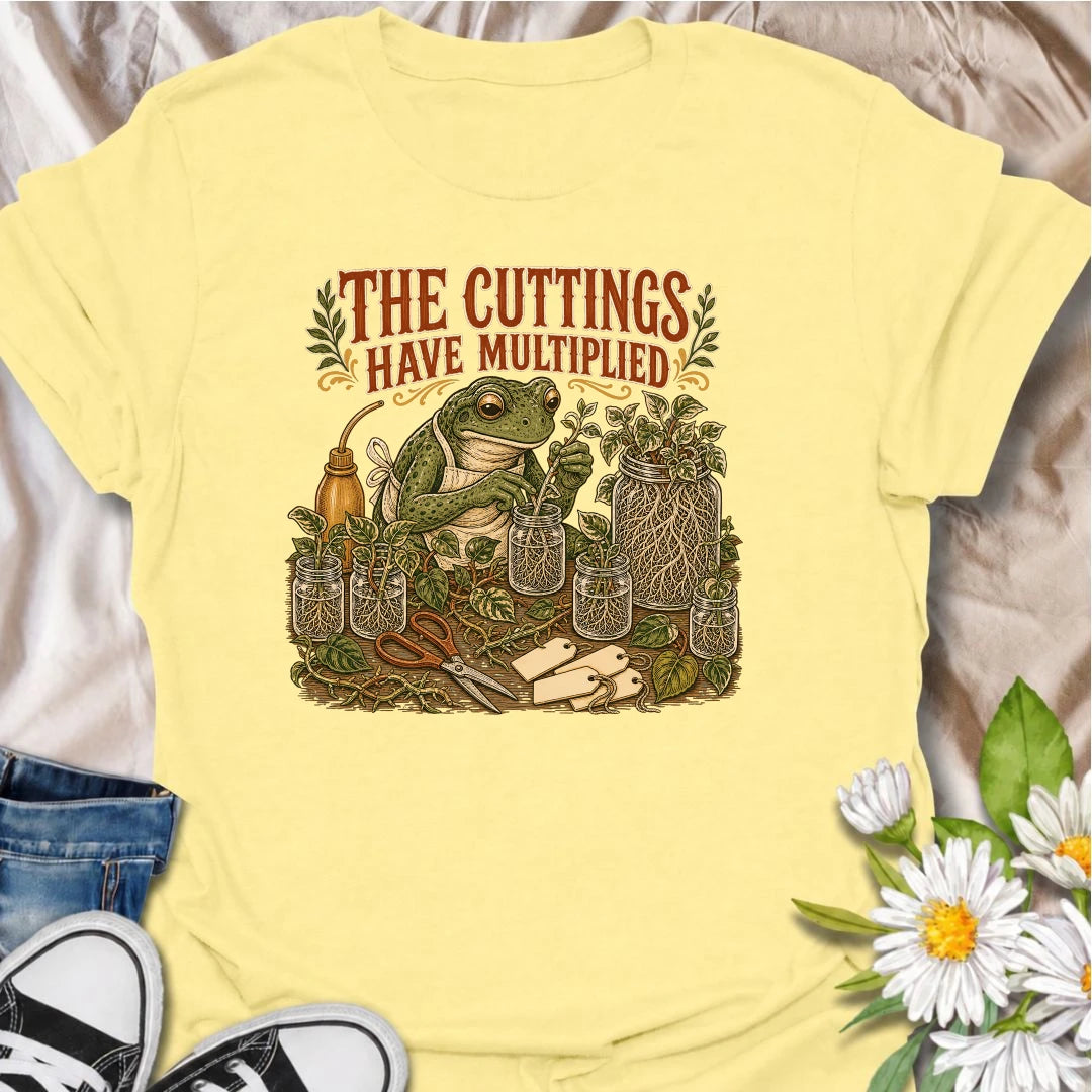 CornsilkCelebrate a propagation collection that keeps growing with this funny “The Cuttings Have Multiplied” T-shirt. Featuring a charming frog surrounded by rooted plant cuttings, glass jars, scissors, and trailing vines, it is perfect for enthusiastic houseplant propagators. A playful gift for plant moms, pothos lovers, and anyone whose plant babies have taken over.