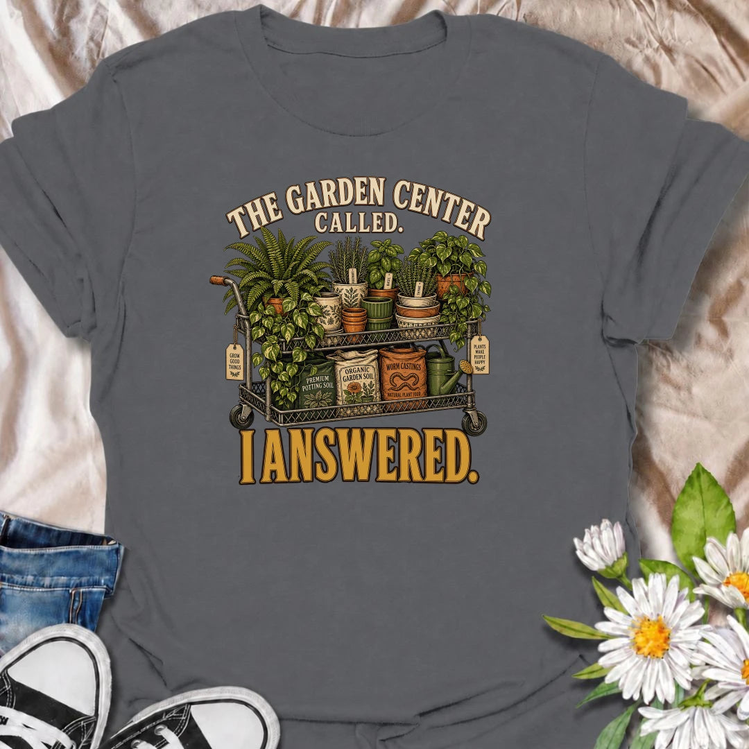 The garden center called—and this plant lover answered. A funny gardening T-shirt featuring a cart packed with plants, pots, soil, and growing supplies.