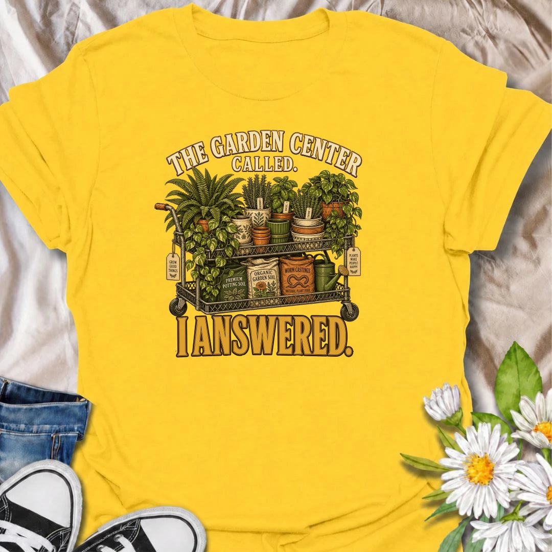 The garden center called—and this plant lover answered. A funny gardening T-shirt featuring a cart packed with plants, pots, soil, and growing supplies.