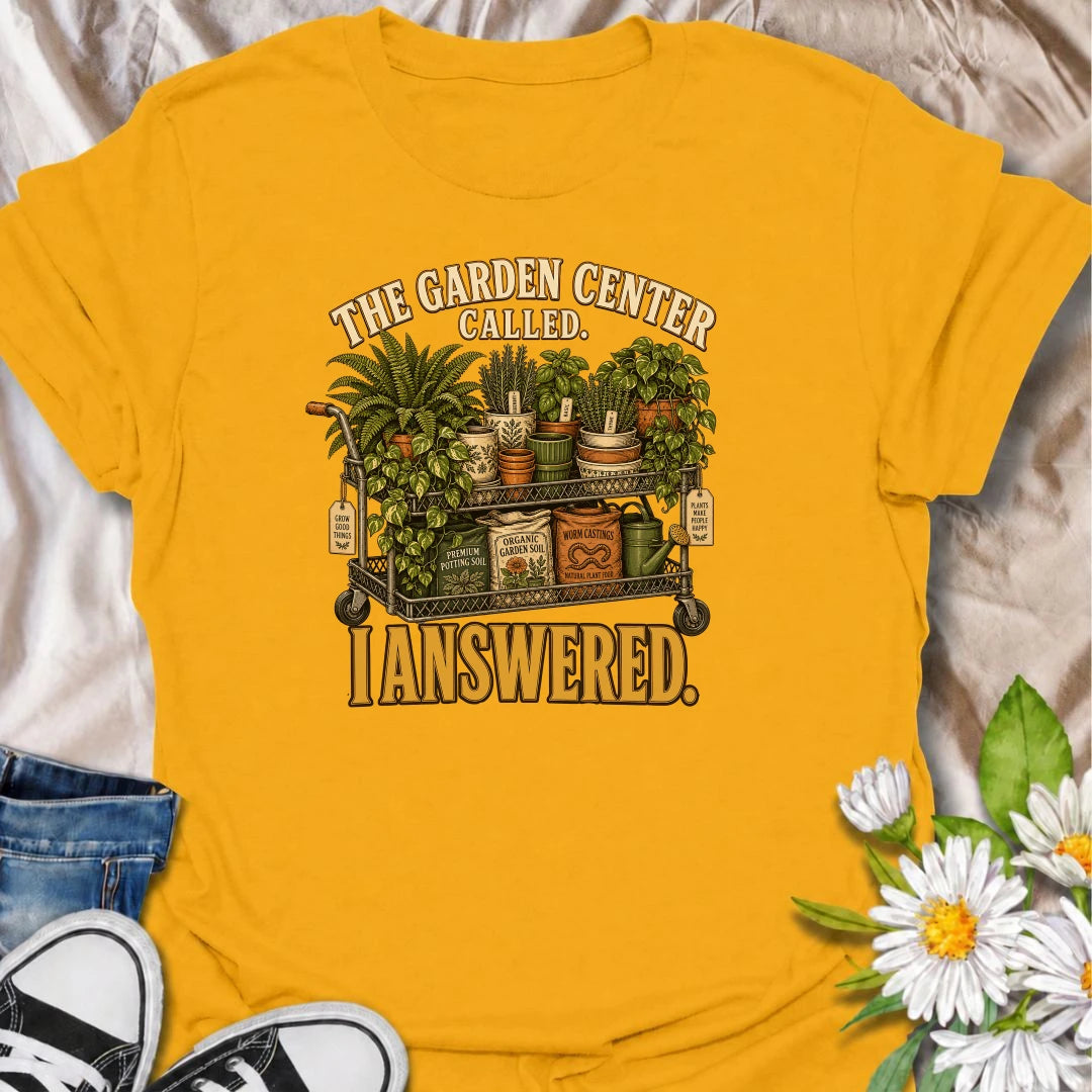 The garden center called—and this plant lover answered. A funny gardening T-shirt featuring a cart packed with plants, pots, soil, and growing supplies.