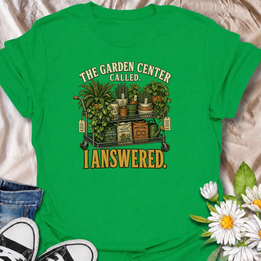 The garden center called—and this plant lover answered. A funny gardening T-shirt featuring a cart packed with plants, pots, soil, and growing supplies.