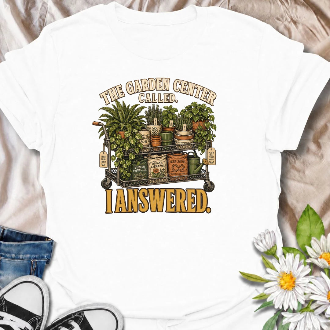 The garden center called—and this plant lover answered. A funny gardening T-shirt featuring a cart packed with plants, pots, soil, and growing supplies.