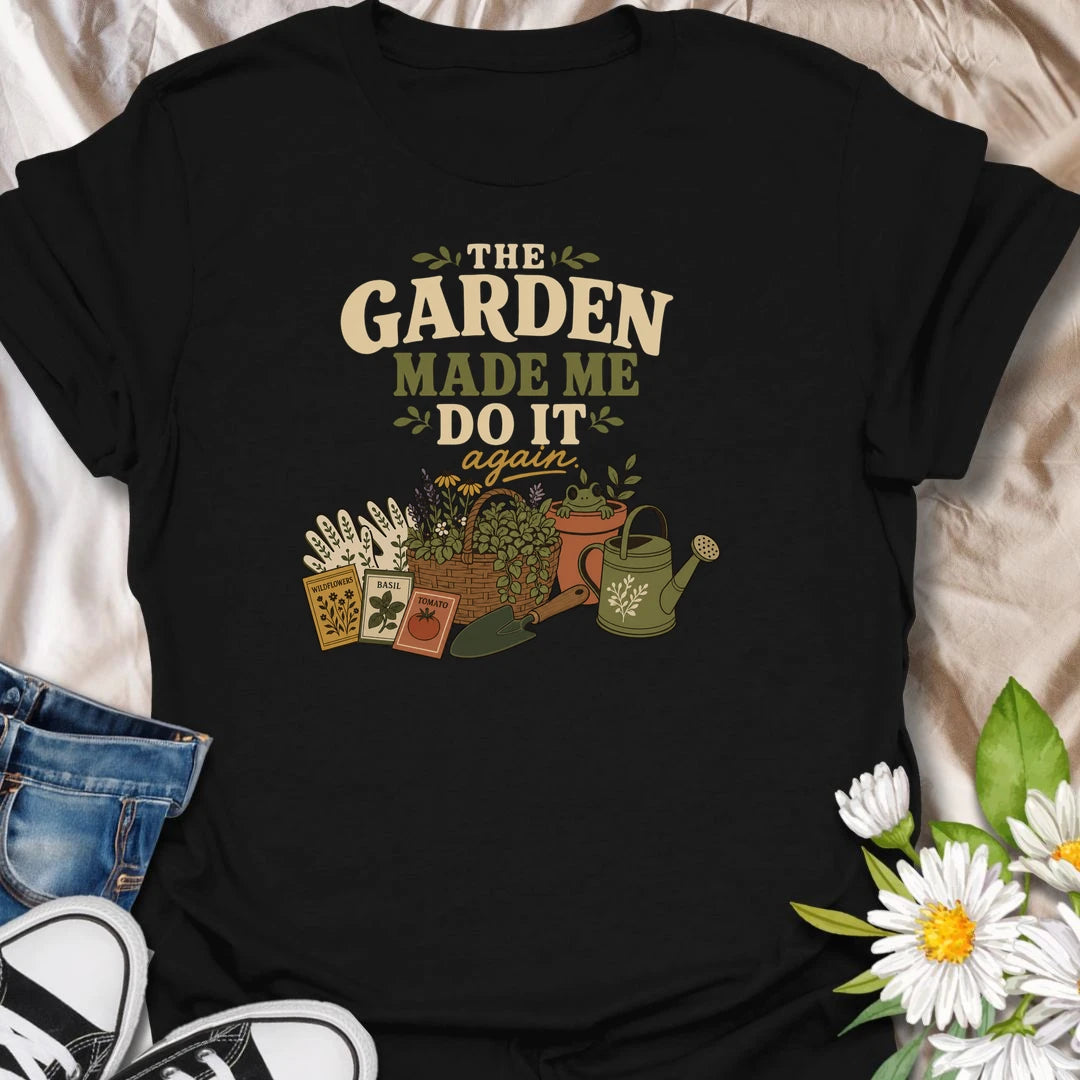 Blame the garden with this playful “The Garden Made Me Do It Again” T-shirt. Featuring gardening gloves, seed packets, a flower basket, watering can, and a curious frog, it captures the irresistible pull of another garden project. A fun choice for gardeners, plant lovers, and enthusiastic seed shoppers.