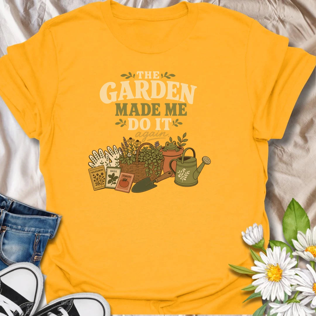 Blame the garden with this playful “The Garden Made Me Do It Again” T-shirt. Featuring gardening gloves, seed packets, a flower basket, watering can, and a curious frog, it captures the irresistible pull of another garden project. A fun choice for gardeners, plant lovers, and enthusiastic seed shoppers.