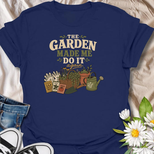 Blame the garden with this playful “The Garden Made Me Do It Again” T-shirt. Featuring gardening gloves, seed packets, a flower basket, watering can, and a curious frog, it captures the irresistible pull of another garden project. A fun choice for gardeners, plant lovers, and enthusiastic seed shoppers.