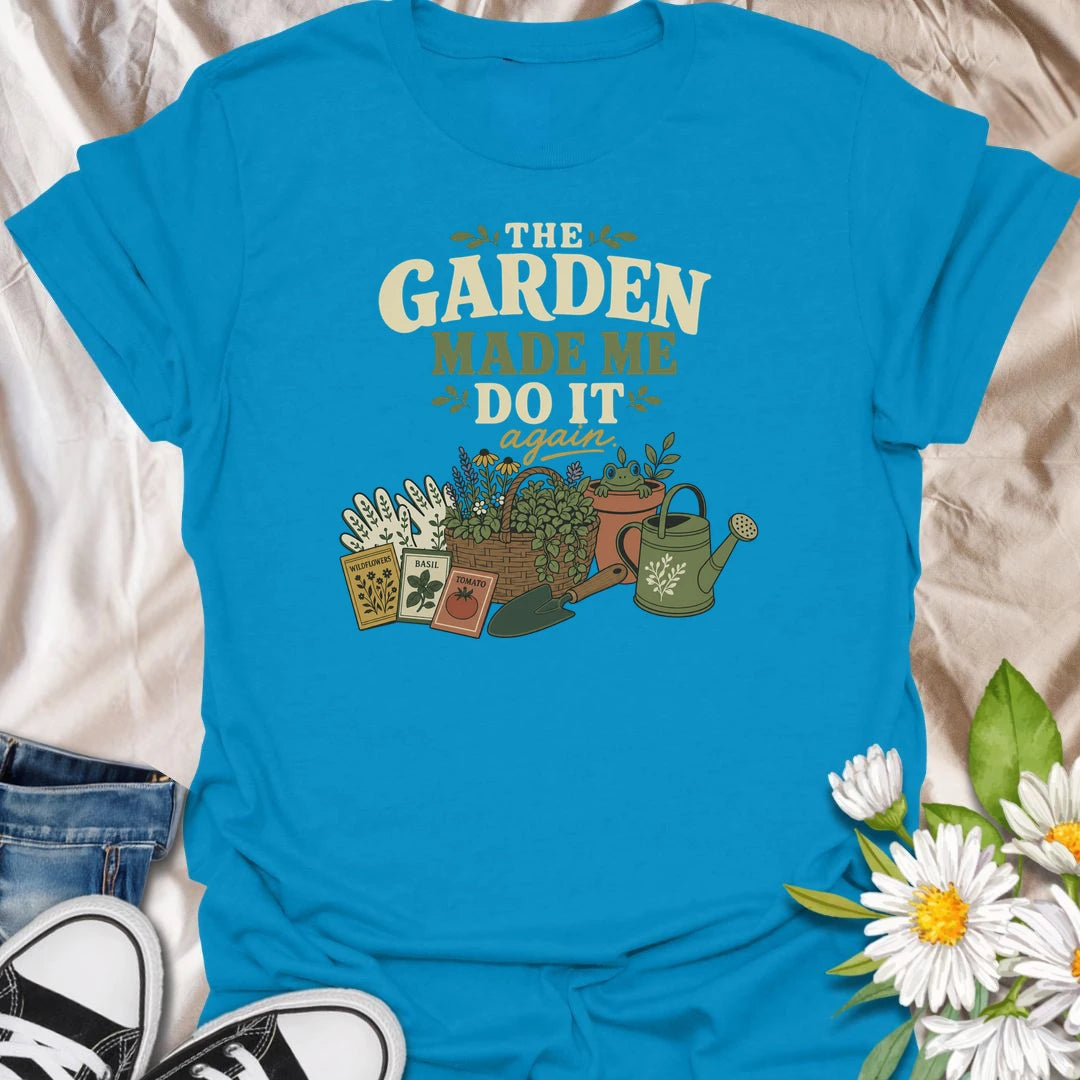 Blame the garden with this playful “The Garden Made Me Do It Again” T-shirt. Featuring gardening gloves, seed packets, a flower basket, watering can, and a curious frog, it captures the irresistible pull of another garden project. A fun choice for gardeners, plant lovers, and enthusiastic seed shoppers.