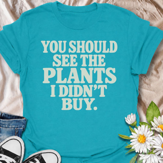 A funny plant T-shirt for anyone whose restraint deserves at least a little recognition. The phrase “You Should See the Plants I Didn’t Buy” delivers dry, self-aware humor that plant parents, nursery regulars, and houseplant collectors will instantly understand. Its bold retro typography keeps the design simple, readable, and easy to wear. It makes a great gift for plant lovers who somehow manage to leave the garden center with fewer plants than they wanted. Perfect for nursery trips, plant swaps, casual we