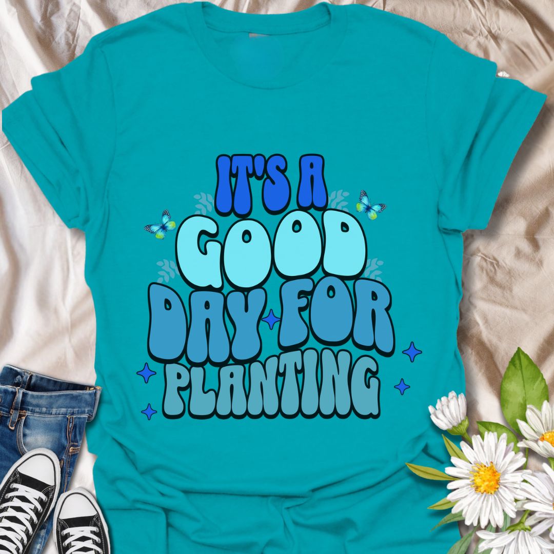 Bright and cheerful "It's a Good Day for Planting" t-shirt featuring retro-style typography with playful butterflies and vibrant blue tones. Perfect for gardeners, plant lovers, and anyone who finds joy in planting flowers and tending to nature. This planting t-shirt is an Ideal gardening gift, outdoor hobby shirt, botanical fashion, nature lover apparel, and springtime outfit.  