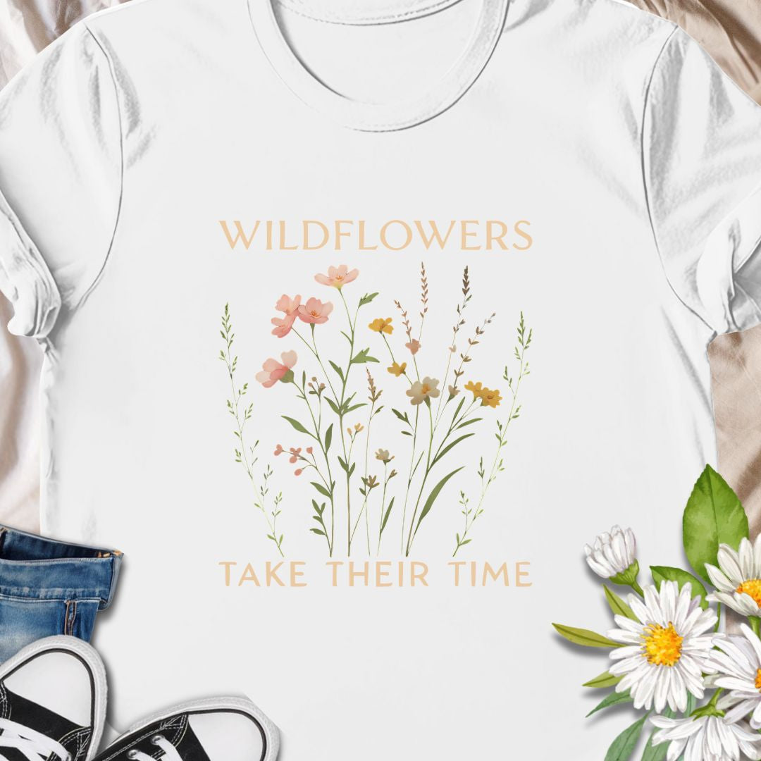 Inspirational wildflower tee featuring soft meadow flowers and motivational quote. A calming nature-themed shirt.